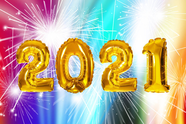 2021 New Year celebration. Creative design with bright gold balloons and fireworks on color background - Foto, afbeelding