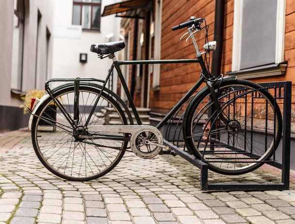 Retro bike near the house on a quiet street - Photo, Image