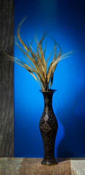 un ramo de espiguillas de oro de cebada madura en un jarrón de metal - Foto, Imagen