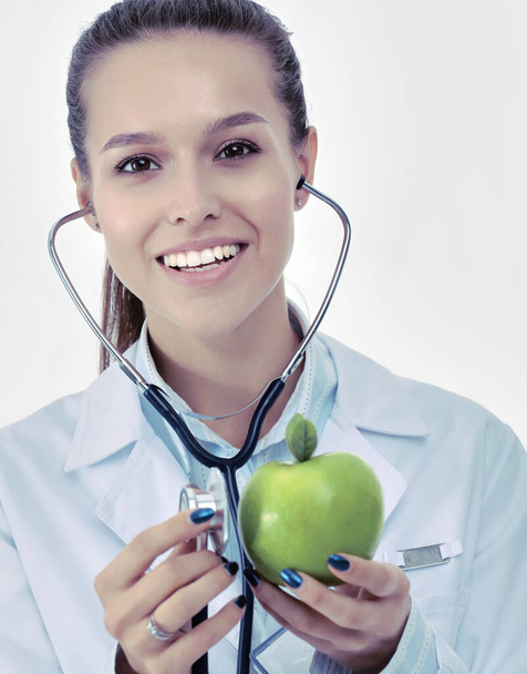 Medical doctor woman examining apple with stethoscope. Woman doctors - Foto, immagini