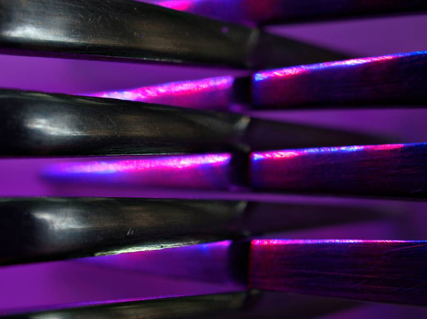 Blurred image of silverware with blue purple light ,blur and bright abstract background for card design, macro and dark - Photo, Image
