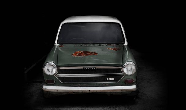 21 June 2020, Chon Buri, Thailand. Vintage Austin car in dark garage - Photo, Image