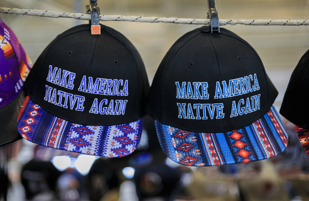 San Francisco, EUA - 08 de fevereiro de 2020: Chapéus bordados com padrão nativo americano e slogan Make America Native Again para venda em um powwow
 - Foto, Imagem