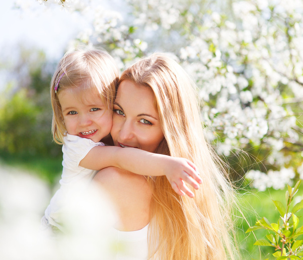 moeder en haar dochtertje in de lente - Foto, afbeelding