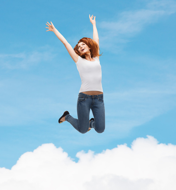 Teenage girl in white blank t-shirt jumping - Φωτογραφία, εικόνα