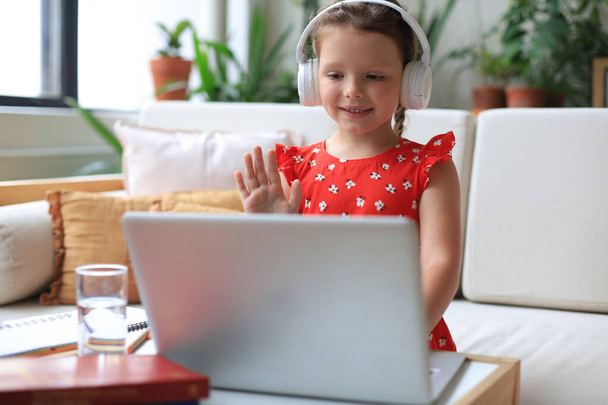 Little girl studing online with video call teacher. Distance learning - Фото, зображення