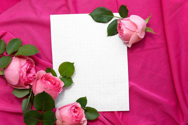 Romantic greeting card with space for text. Pink roses on fabric with paper. Frame for inscription. Congratulations on 8 march, valentains day, mothers day, birthday. Surprise to girl, girlfriend, mom - Photo, image