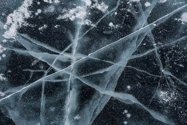 Ice texture close-up. Frozen Baikal lake in Siberia. Beautiful cracked ice with air and methane bubbles.  - Photo, Image