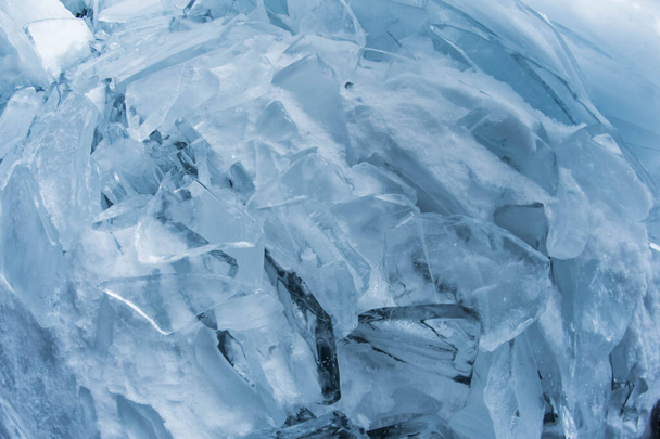 Ice texture close-up. Frozen Baikal lake in Siberia. Beautiful cracked ice with air and methane bubbles.  - Photo, Image