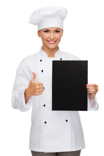 Smiling female chef with black blank paper - Foto, afbeelding