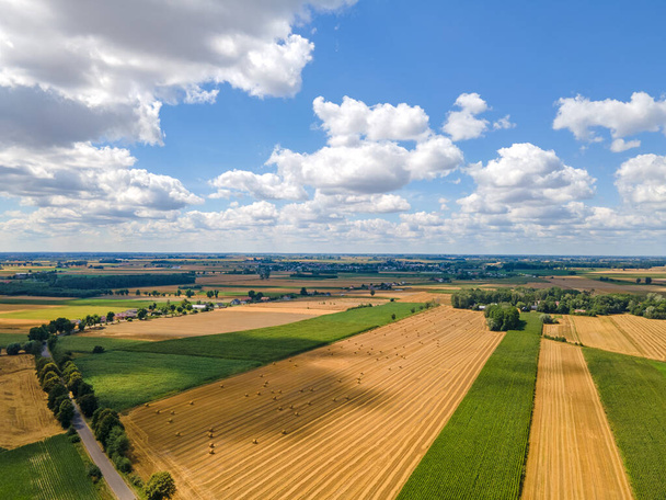 Bales of hay on the field after harvest shot by drone. Aerial drone photo of Poland country - Fotoğraf, Görsel