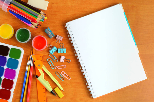 Back to school concept. School supplies and an open notebook on a writing desk or school desk, close up. Top view, flat lay, place for text, copy space. - Foto, immagini