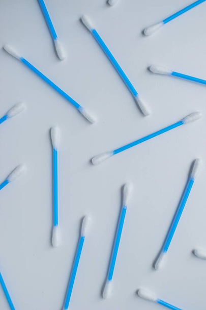 Cotton sticks ear blue plastic on a white background. Personal hygiene and care. Cosmetology and medicine. - Фото, изображение