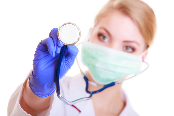 Woman in mask and lab coat. Doctor nurse with stethoscope. - Foto, afbeelding
