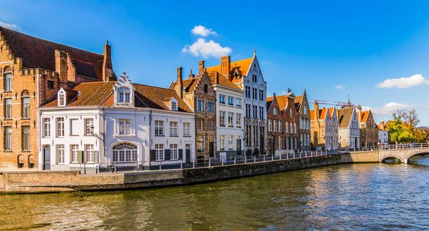 Bruges kanalı Spiegelrei 'de gün batımında güzel evler. Panoramik şehir manzaralı geleneksel binalar ve su kanalı. - Fotoğraf, Görsel