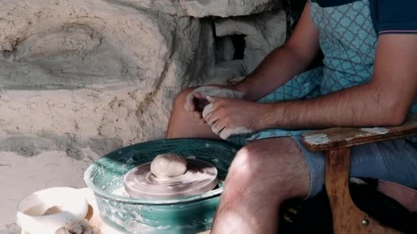 Artisan potter prepares material for his pottery. Strong male hands squeeze wet clay for modeling and sculpting. Work close-up. Pottery working, handmade and creative skills. - Materiał filmowy, wideo