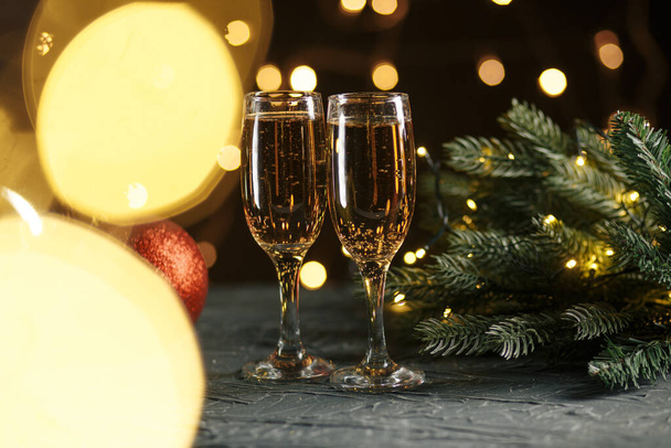 Ribbon, baubles and wine against Christmas lights - Valokuva, kuva