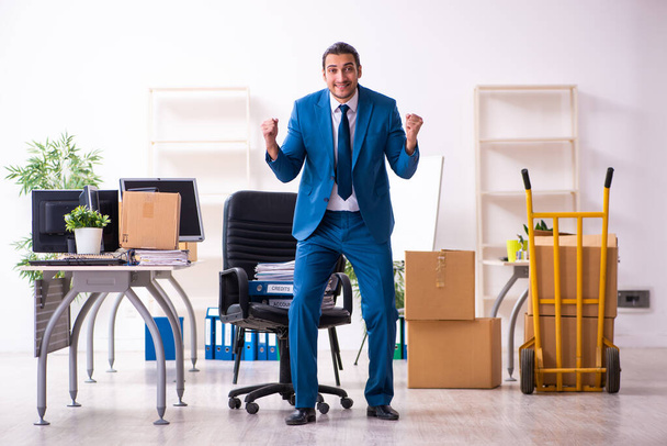 Young male employee in moving concept - Photo, Image