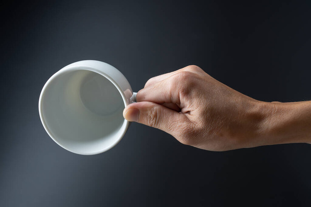 hand holding cup on black background - Photo, Image
