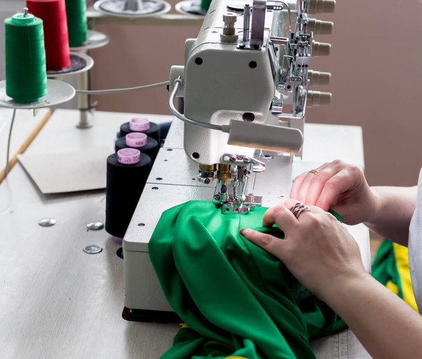 Designer tailor sew the dress. Woman use sewing machine for his work. - Foto, imagen