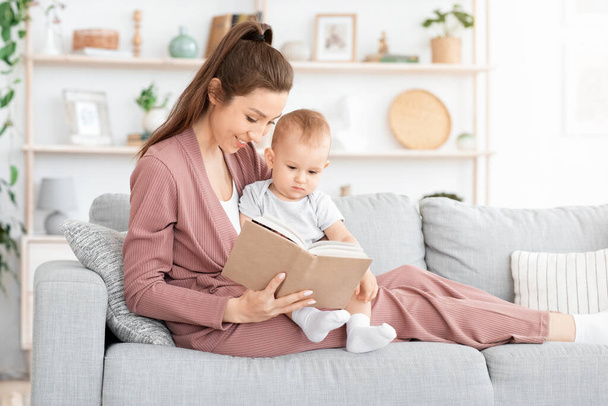 Loving Mom Reading Fairy Tales To Her Adorable Toddler Son At Home - Foto, afbeelding