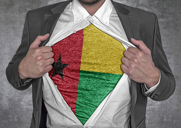 Business man show t-shirt flag of Guinea Bissau rips open his shirt  - Foto, Imagem
