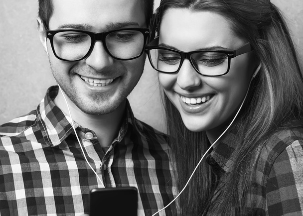Young couple listening music together - Фото, изображение
