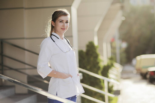 Portrait of a beautiful female doctor or nurse. Prevention Covid-19 healthcare concept. Stethoscope over the neck. Woman, girl. - 写真・画像