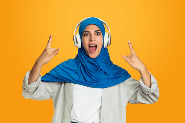 Portrait of young muslim woman isolated on yellow studio background - Foto, Imagem