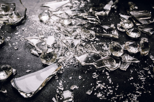 top view of crystals and broken glass on black background - Foto, imagen