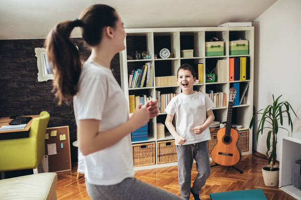 Children exercising at home. Family working out at home. - Photo, image