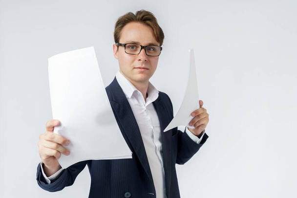 Businessman with scattered papers. Business, people, emotions - businessman throws documents in the office. Business and finance concept. - Foto, afbeelding