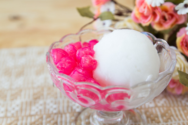 White ice cream made from coconut and pink jelly topping on the - Photo, Image