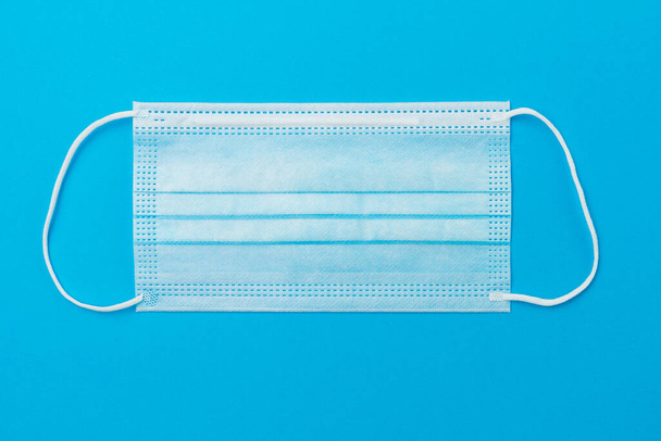 Classic surgical medical mask on paper background with copy space. - Foto, immagini