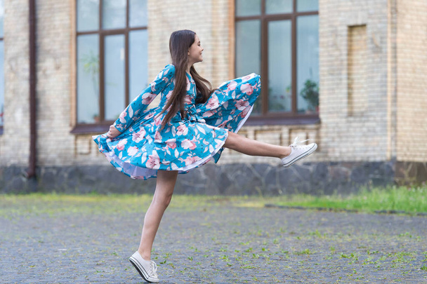 Girl summer dress flutters in motion urban background, against wind concept - Photo, Image