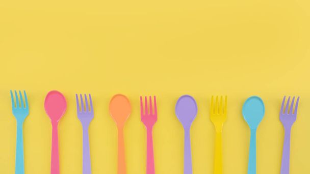 primer plano de cucharas de plástico sobre fondo amarillo - Foto, Imagen