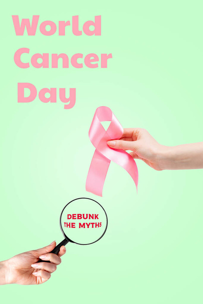 World cancer day. Women's hand with a pink ribbon and a magnifying glass on a light green background. Vertical orientation. Copy space. Debunk the myths. - Photo, Image