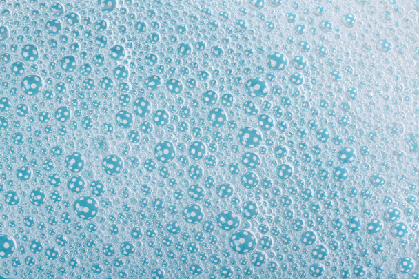 achtergrond van suds met bubbels blauwe close-up - Foto, afbeelding