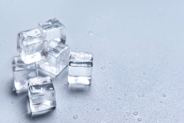 Ice cubes on grey background - Foto, afbeelding