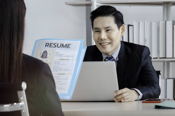 Job interview concept, woman holding her resume paper for giving to businessman manager, candidate giving CV to human resources officer - Photo, Image