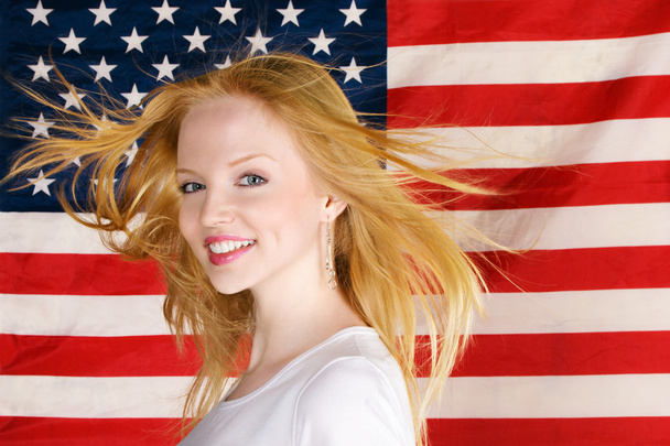 Beautiful teen girl against american flag - Photo, image