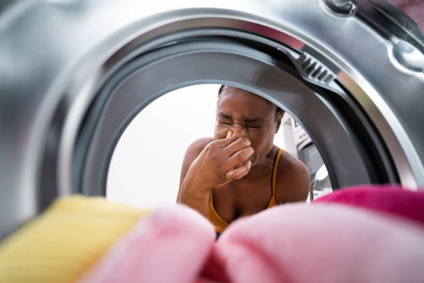 Broken Smelly Washing Machine. Woman Washing Towel - Φωτογραφία, εικόνα