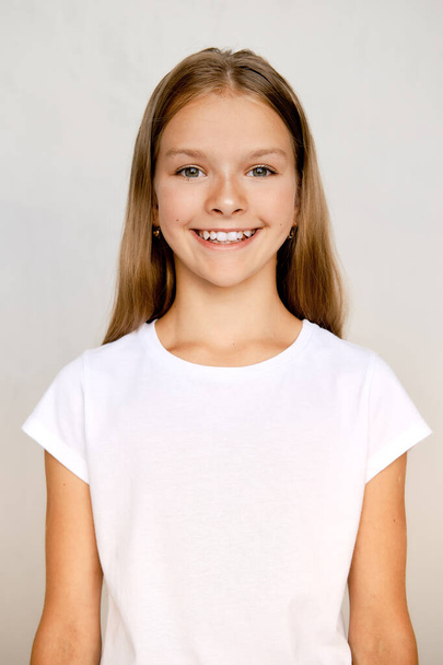 Portrait of positive teenager girl standing straight - Foto, Imagem