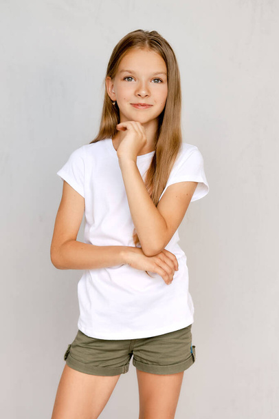 Portrait of positive teenager girl with hand near chin - Foto, immagini