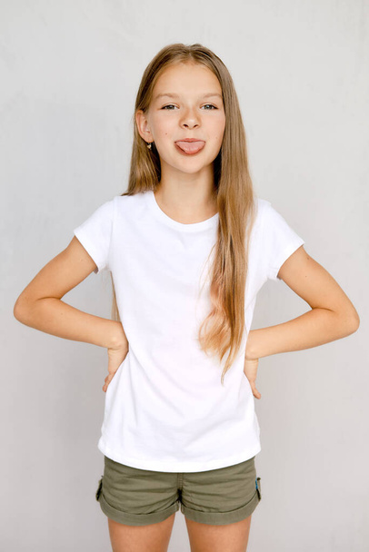 Portrait of positive teenager girl sticking out tongue - Fotografie, Obrázek