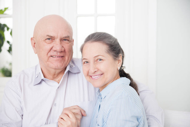 Portrait of  cute elderly couple in light interior. - Valokuva, kuva