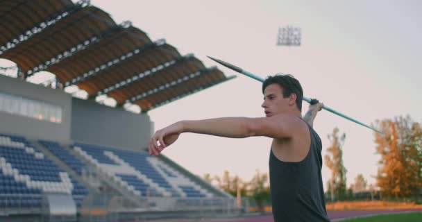 Javelin thrower before a throw. Concentration and exhalation. Excitement and fear before the throw. Confident look and run at the stadium of an athlete performing the javelin throw - Footage, Video