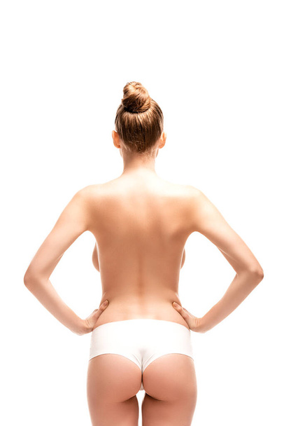 back view of young woman standing with hands on hips isolated on white  - Φωτογραφία, εικόνα