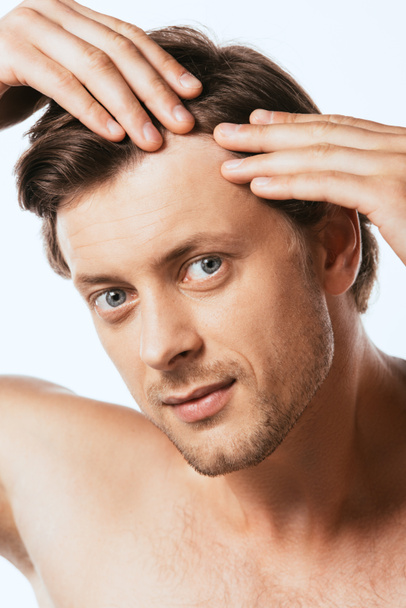 Shirtless man touching hair and looking at camera isolated on white - Photo, Image