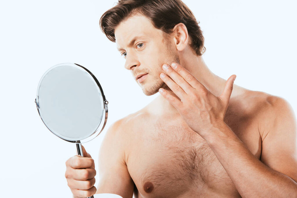 Shirtless man touching skin while holding mirror isolated on white - Photo, Image